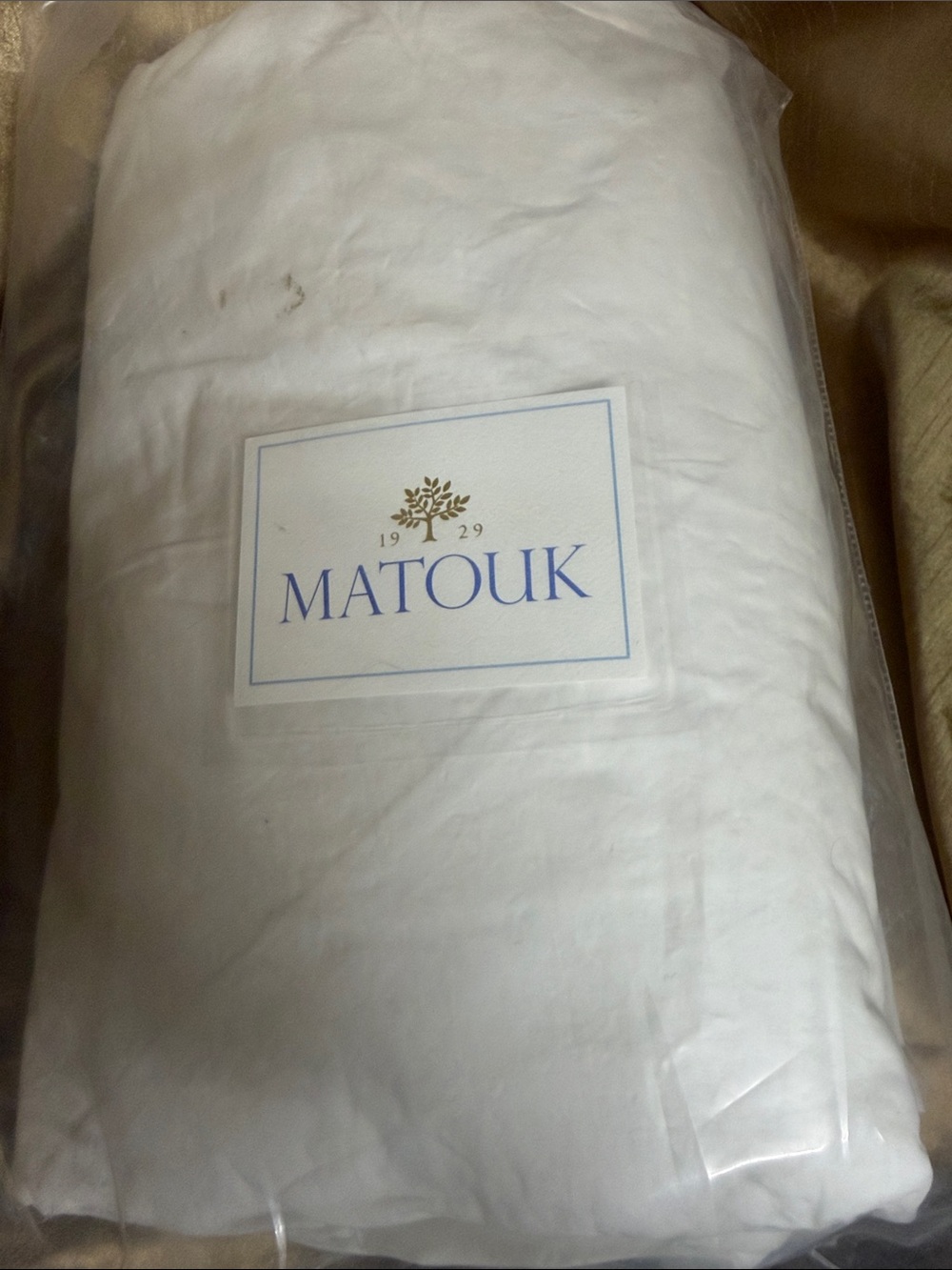 Matouk White Sheets with Gold Logo and Blue Accent